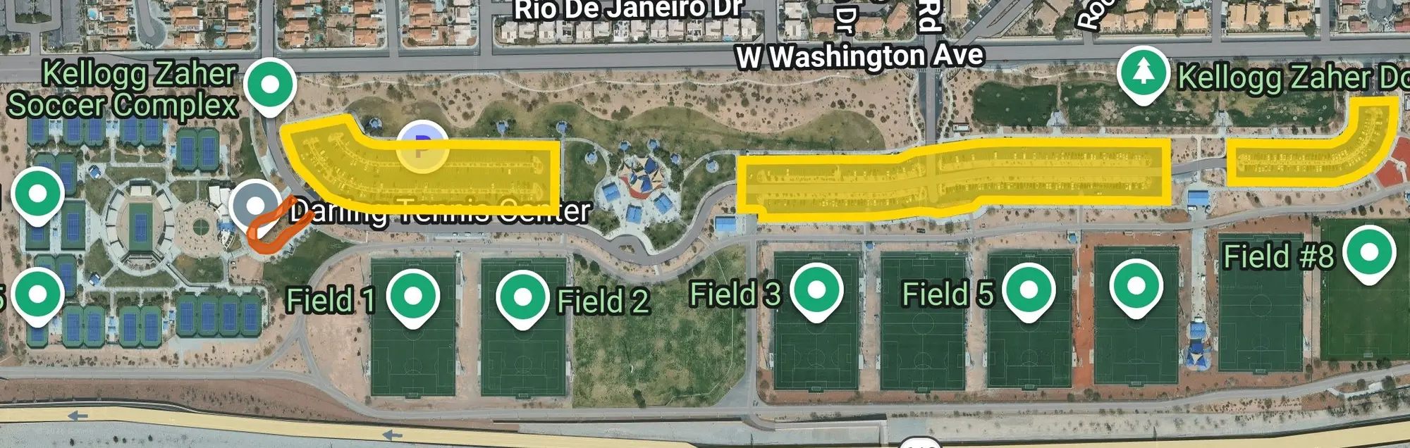 Aerial map of Darling Tennis Center and Kellogg Zaher Park in Las Vegas, NV. The three public parking lots are highlighted in yellow, running west to east on the south side of W Washington Avenue, and the drop-off and pickup loop at the tennis center entrance is outlined in red.